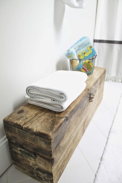 A big wooden toolbox is perfect for bathroom storage kellyelko.com