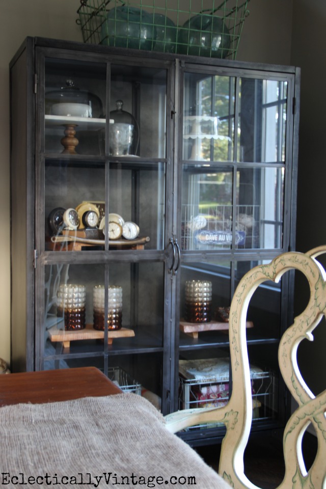 This industrial glass front cabinet is massive - and perfect for storage in a dining room kellyelko.com
