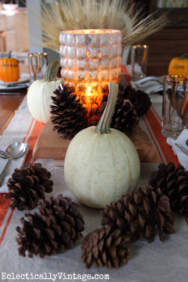 White pumpkins, pine cones, wheat and pops of orange create a gorgeous fall Thanksgiving table kellyelko.com