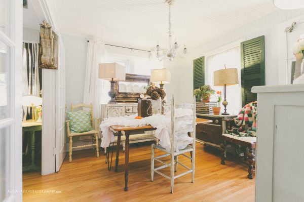 Cozy cottage kitchen with fun mismatched furniture - love the shutters framing the window kellyelko.com