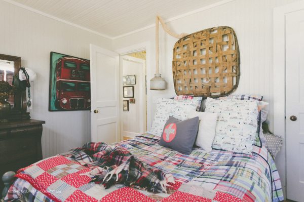 Vintage flea market quilts and tobacco basket add charm to this cottage bedroom kellyelko.com