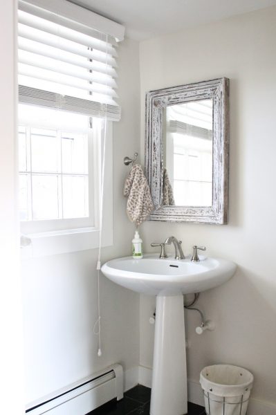 Love the rustic wood mirror in this powder room kellyelko.com