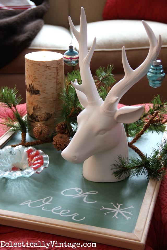 An old chalkboard becomes a tray for a Christmas display - love the ceramic stag head kellyelko.com