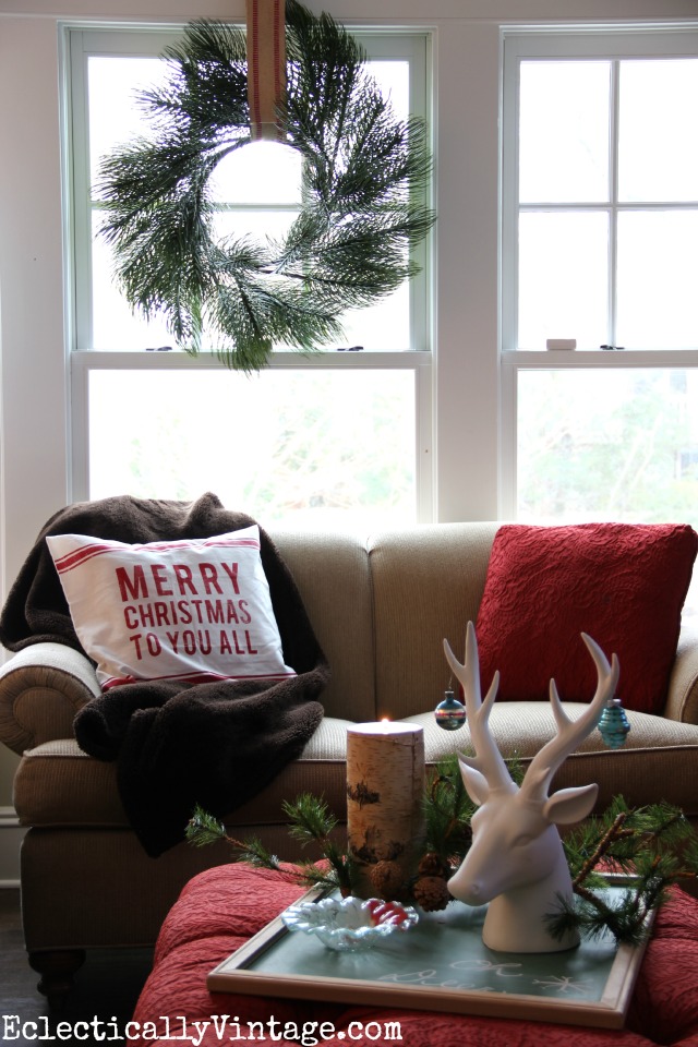 Christmas decorating ideas - love this cozy family room with the fur throw and the festive wreath kellyelko.com