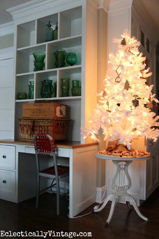 Festive Christmas kitchen - love the white flocked Christmas tree with the corkscrew ornaments kellyelko.com