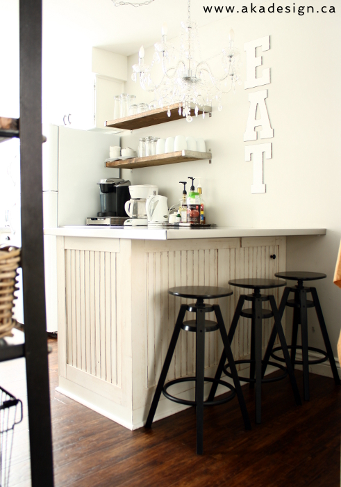 Breakfast bar in this small kitchen - love the EAT sign and open shelves kellyelko.com