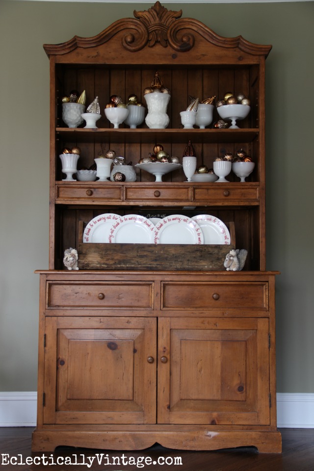 Christmas hutch filled with milk glass and ornaments kellyelko.com