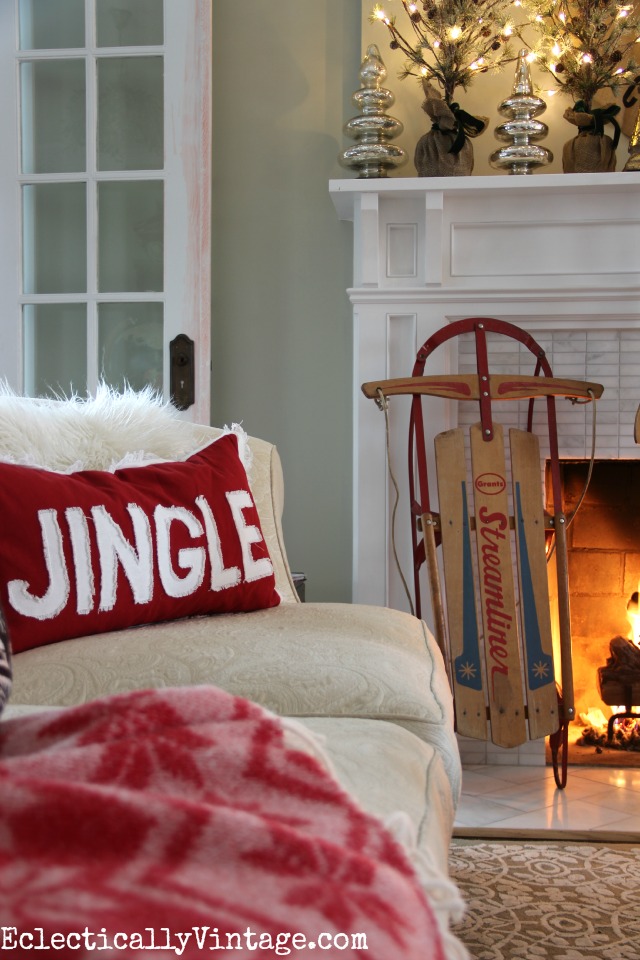 Vintage sled is fun to bring inside for Christmas decorating - love the Jingle pillow too! kellyelko.com
