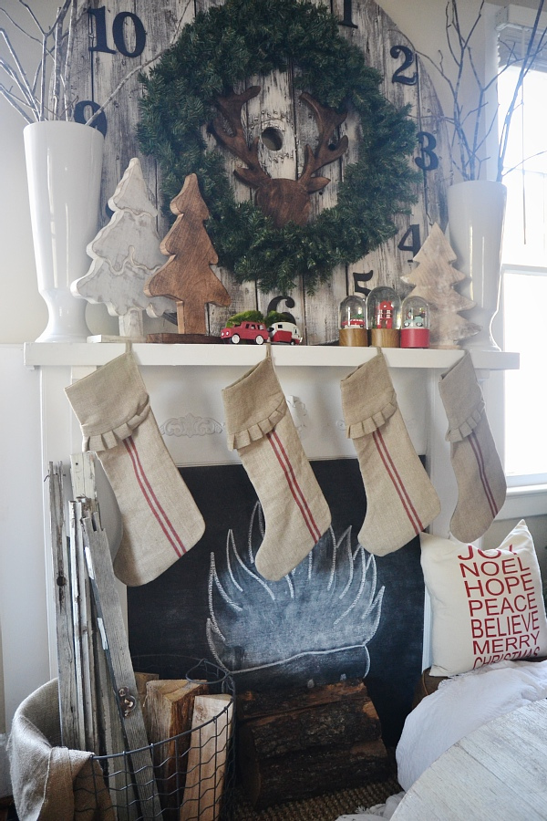 Festive mantel - love the pallet clock and the grain sack stockings kellyelko.com