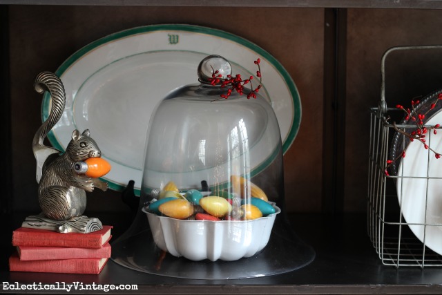 Vintage Christmas bulb display under a cloche kellyelko.com