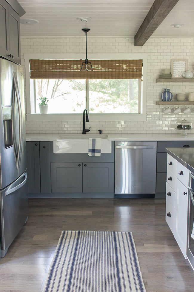 This kitchen is a stunner - from the floor to ceiling subway tile to the plank ceiling to the gray cabinets ... kellyelko.com