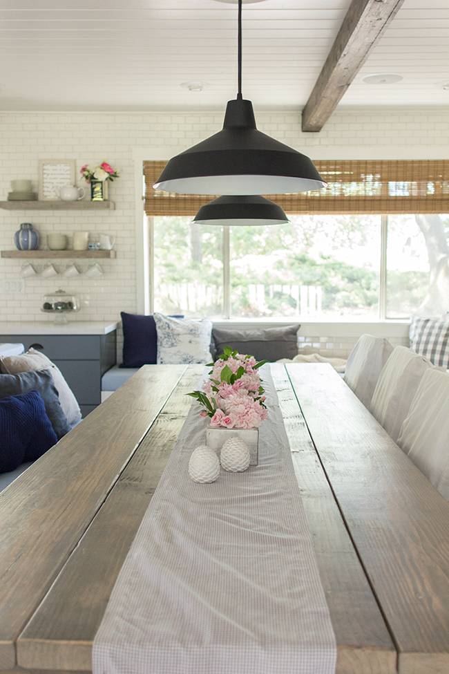 Stunning farmhouse kitchen with subway tile, industrial lighting and a gorgeous table kellyelko.com