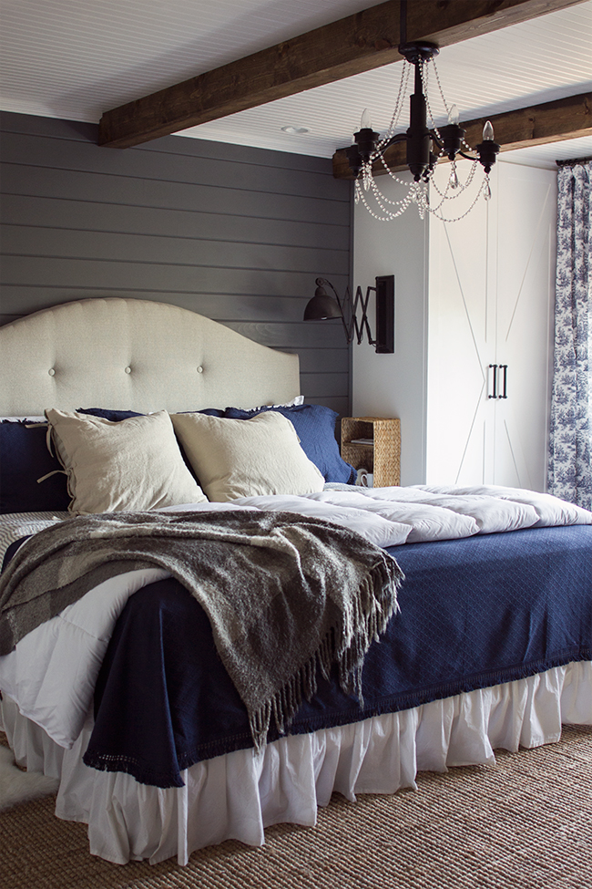 Cozy master bedroom - love the gray planked walls, beams on the ceiling, built in cabinets instead of bed side tables and more kellyelko.com