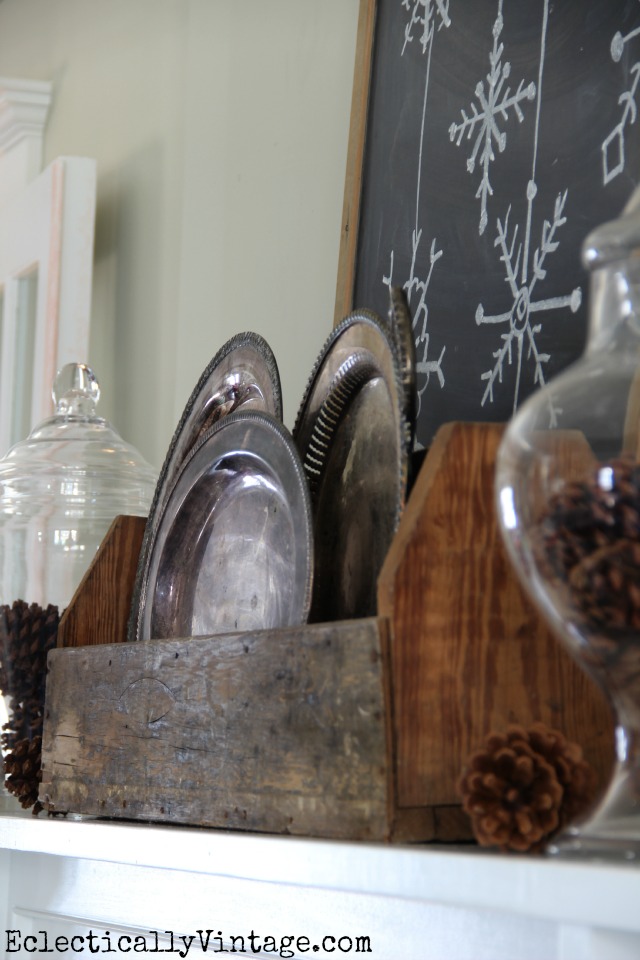 Create a rustic mantel with a few simple elements like tarnished silver and weathered wood kellyelko.com