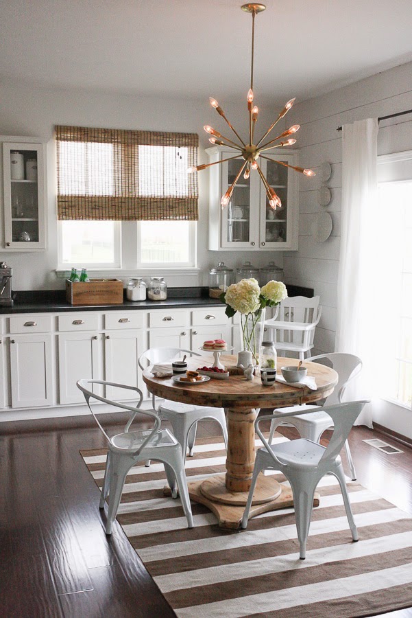 Modern sputnik chandelier mixes with traditional kitchen furniture kellyelko.com