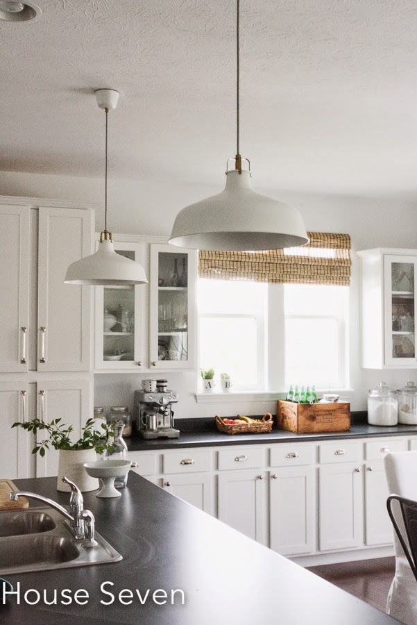 White kitchen with industrial pendant lights kellyelko.com