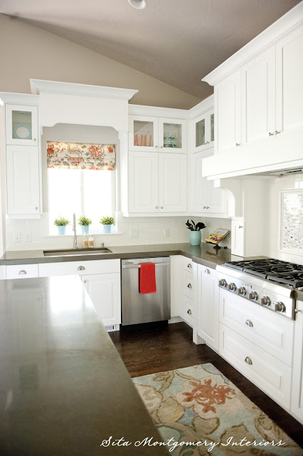 Beautiful white kitchen gets fun color from a window treatment and rug kellyelko.com