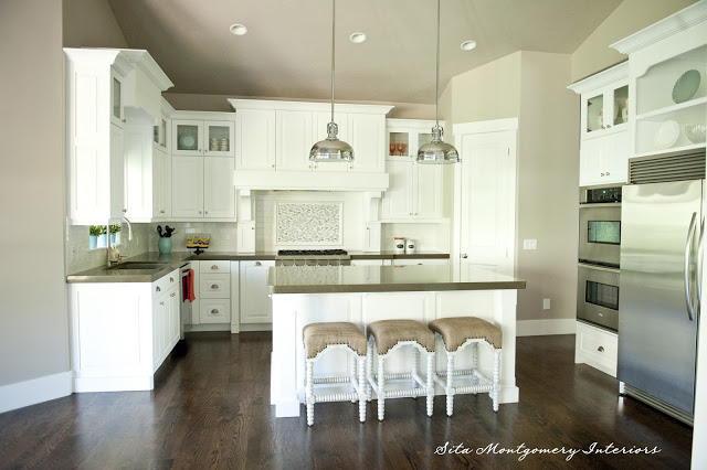 Gorgeous white kitchen - love the two pendant lights and the top glass cabinets kellyelko.com