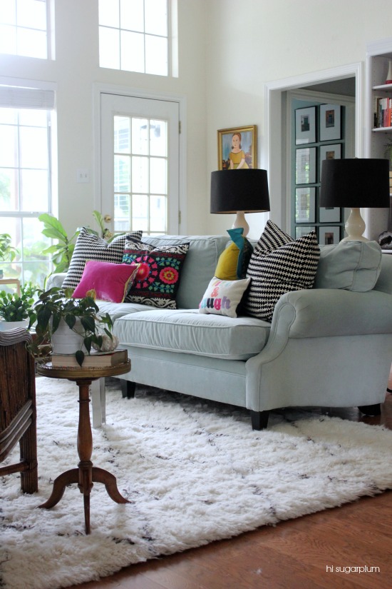 Love this gorgeous living room with pale blue sofa and colorful pillows kellyelko.com