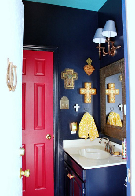 Bold black bathroom walls with red door - love the collection of 21 crosses kellyelko.com