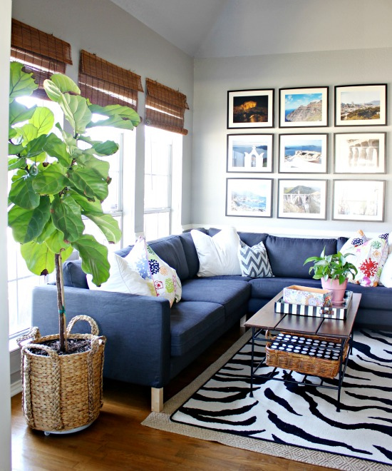 Fun, colorful and eclectic family room - love the blue sectional sofa, vacation photo gallery wall and fiddle leaf fig kellyelko.com