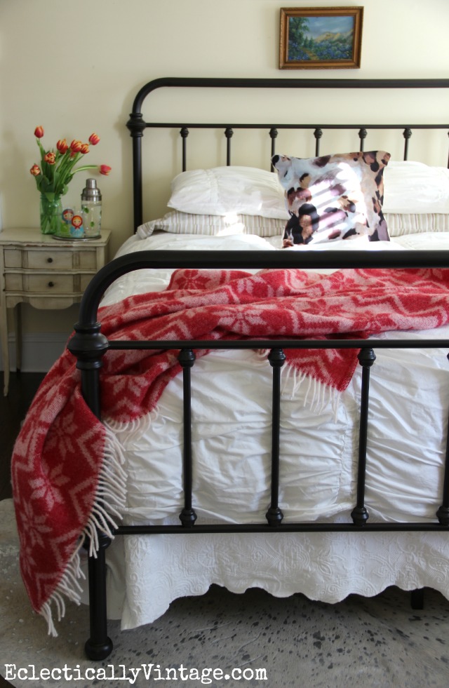 This is such a beautiful bedroom - love the iron bed and the red throw kellyelko.com