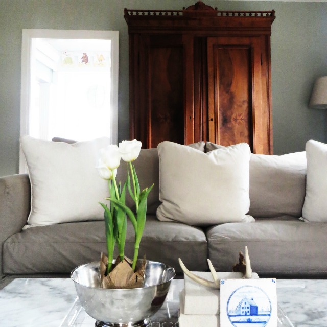 Love the antique wood armoire in this neutral living room kellyelko.com