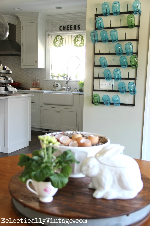 Fun for the kitchen - this HUGE bottle drying rack is perfect for mason jars - and she shows other creative ways to style it plus where to buy kellyelko.com #farmhouse #farmhousedecor #farmhousekitchen #platewall #vintagedecor #vintagekitchen #eclecticdecor #colorfuldecor #masonjars #springdecor #summerdecor 