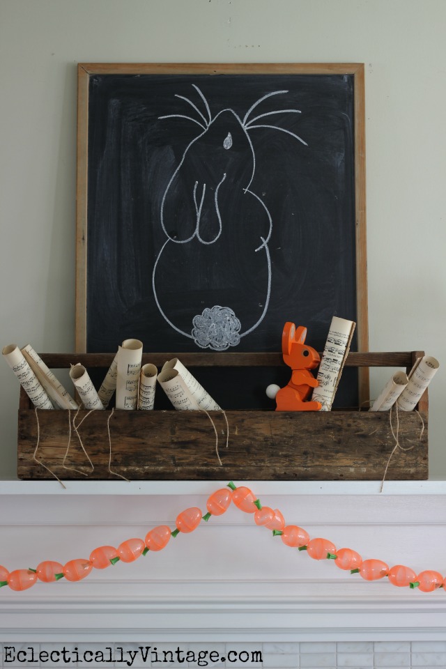 I love this spring mantel - the toolbox filled with music sheets and the adorable DIY carrot garland! kellyelko.com