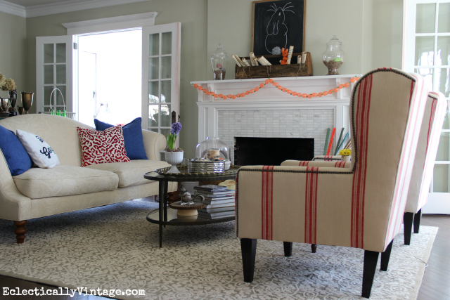 Love this light and bright living room and those red grain sack chairs! kellyelko.com