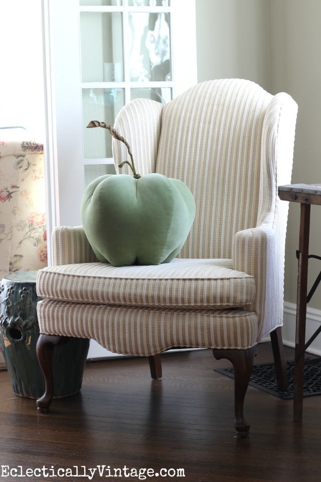 Love the neutral wing back chair with the fun apple pillow! kellyelko.com