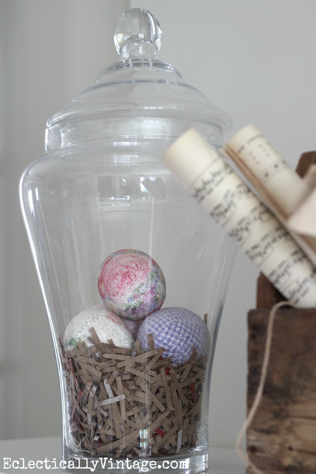 Apothecary jars are perfect for seasonal decorating - love it filled with shredded paper and eggs on this spring mantel kellyelko.com