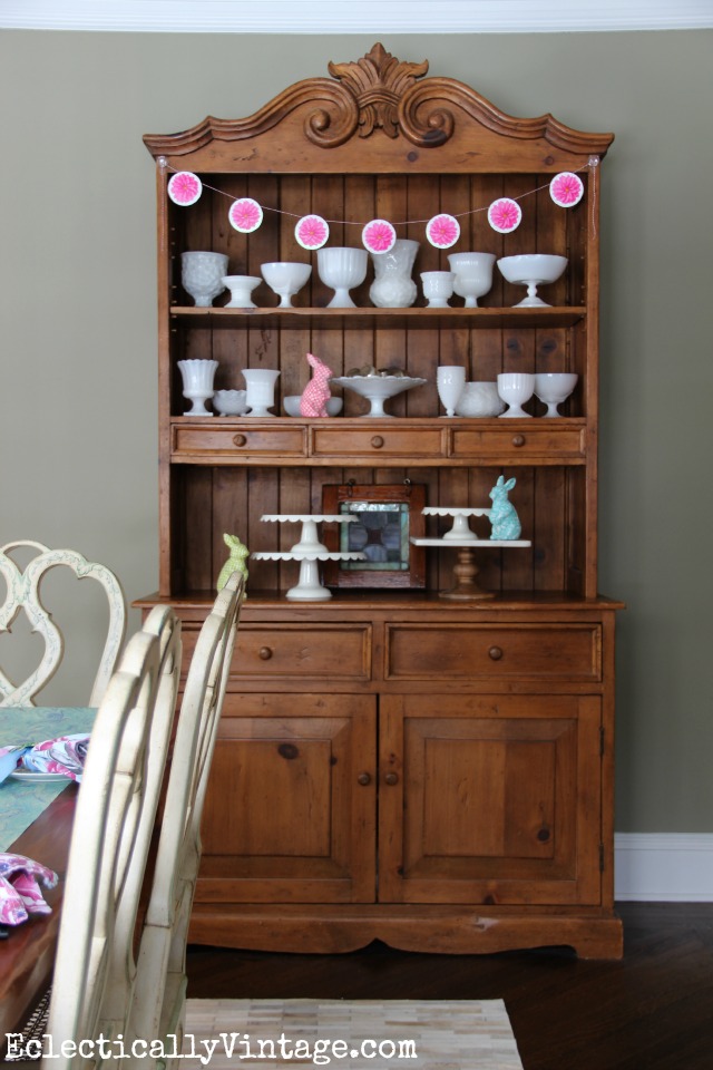 Love this dining room hutch decked out for spring - the milk glass collection is beautiful kellyelko.com