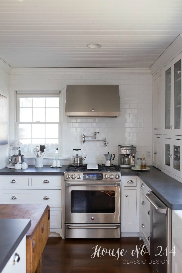 Love the white subway tile going to the ceiling and the bead board ceiling - beautiful white kitchen kellyelko.com