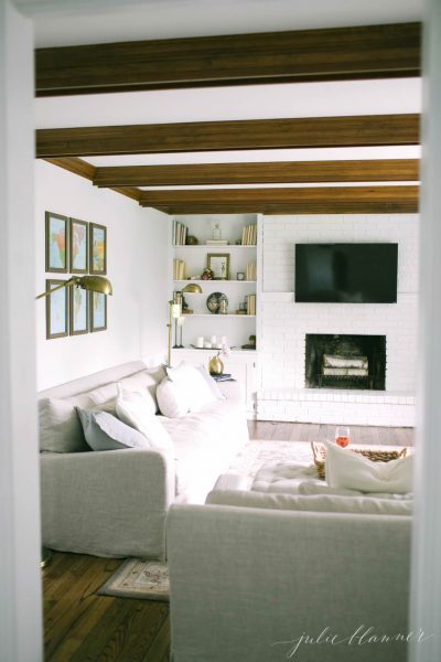 Love the rustic ceiling beams in this family room kellyelko.com