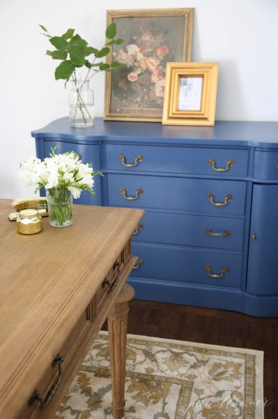 Love the peacock blue dresser in this home office kellyelko.com