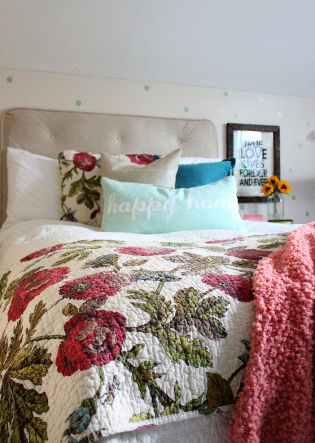 Love this cheery bedroom - the floral quilt and the polka dot walls kellyelko.com