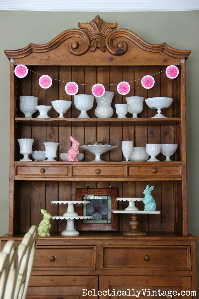 Love this dining room hutch filled with vintage milk glass kellyelko.com