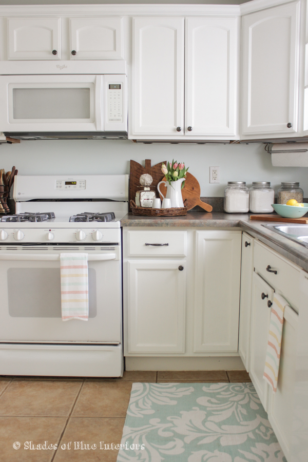 Give your dated kitchen cabinets a fresh coat of white paint for an instant kitchen update kellyelko.com