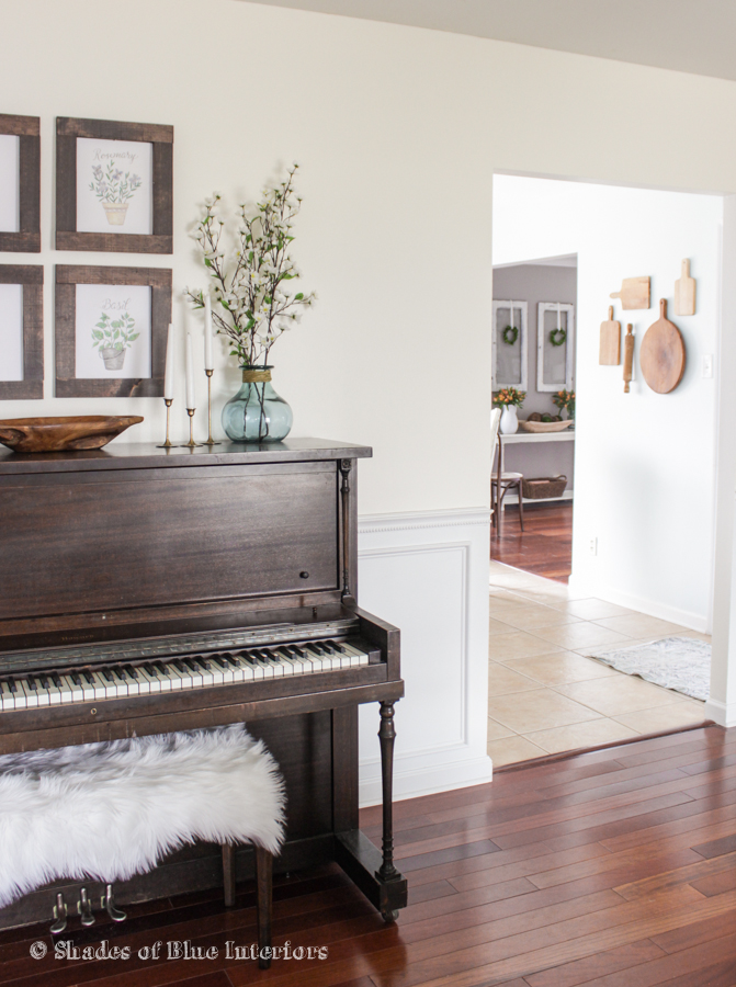 Love a piano in a home - and the cutting board collection hung on the wall kellyelko.com