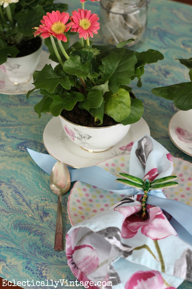 Spring table decorations - love the table runner and the vintage teacups filled with flowers kellyelko.com