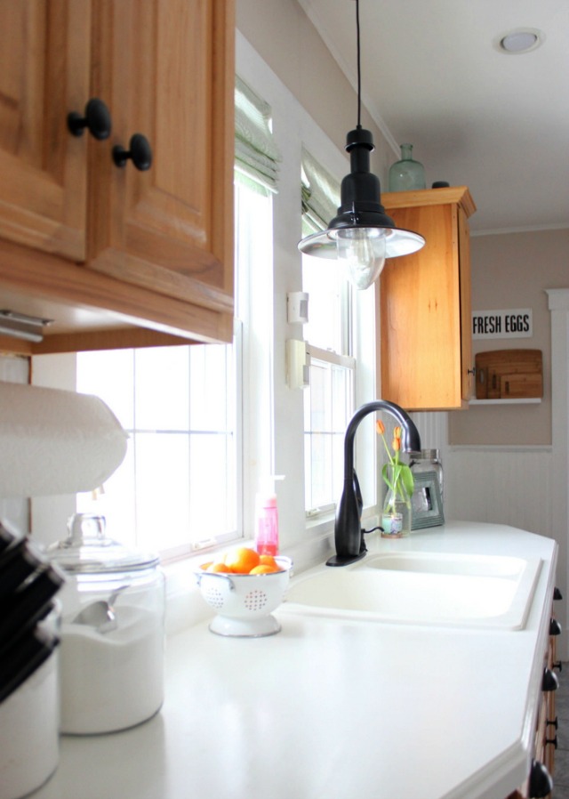 Love the industrial pendant light over the kitchen sink kellyelko.com