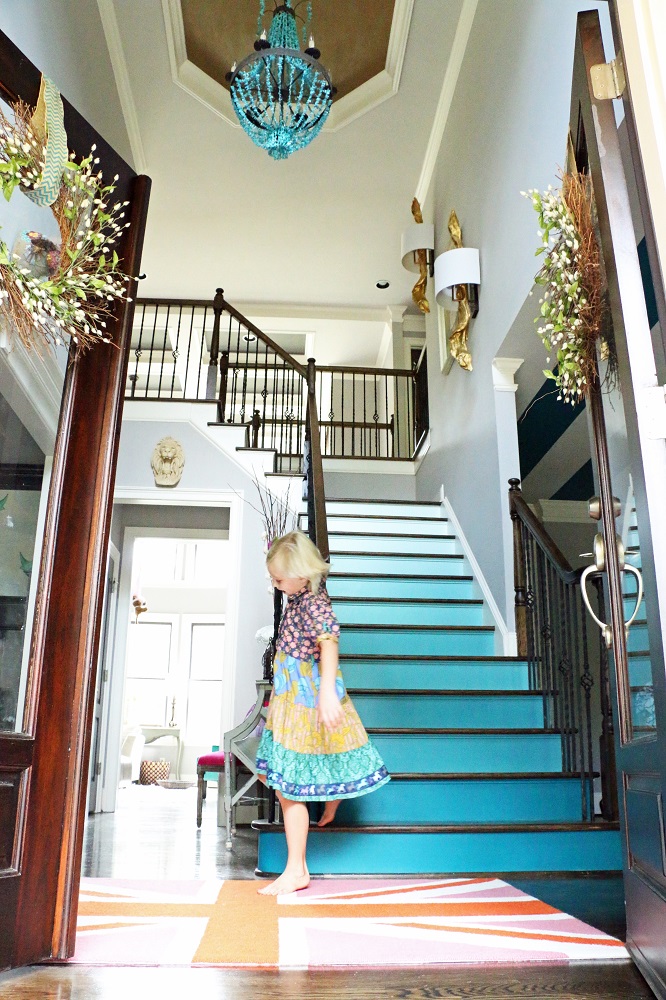 Love the colorful blue ombre stairs in this colorful home tour kellyelko.com