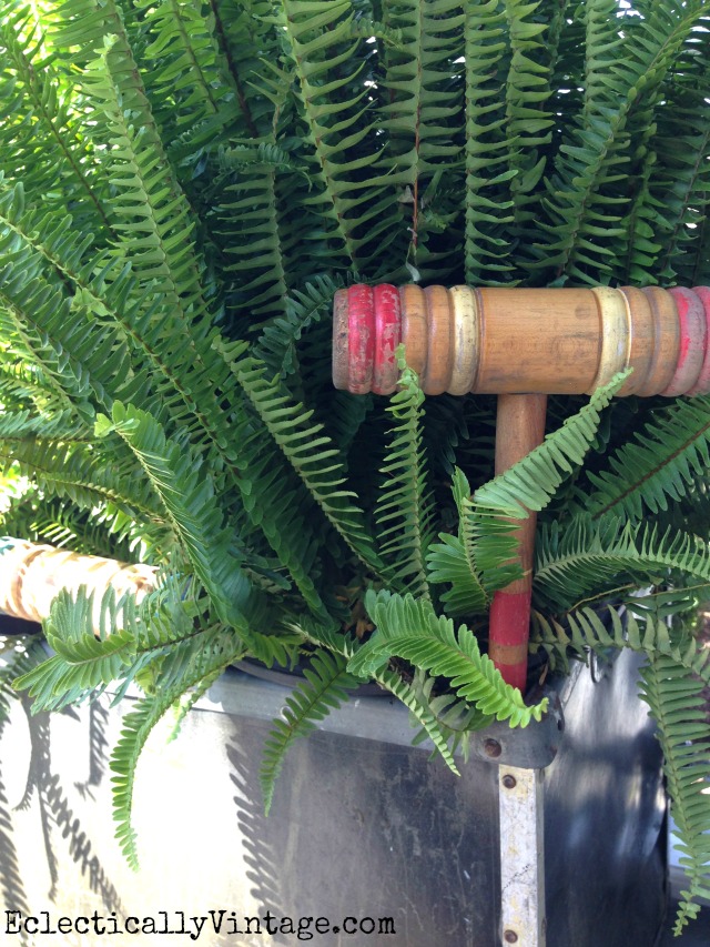 Tuck vintage finds like this croquet mallet into your plants - love this summer front porch kellyelko.com