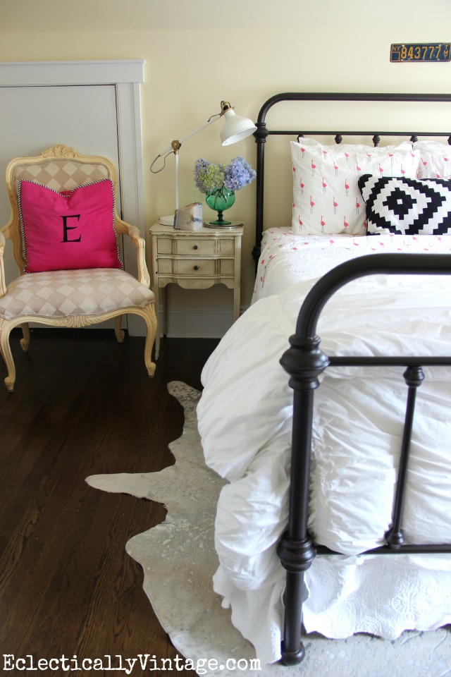 Love this cozy guest bedroom - the flamingo sheets, the Ikea finds (lamp and pillow), the silver cowhide kellyelko.com