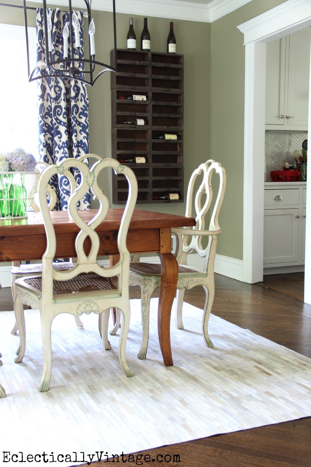 I'm in love with everything about this dining room - the wine racks, the farmhouse table, the cowhide rug, the lantern chandeliers kellyelko.com