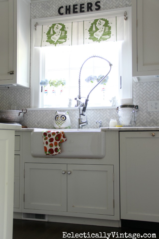 Love this kitchen - the farmhouse sink, the dish towel window treatment ... kellyelko.com