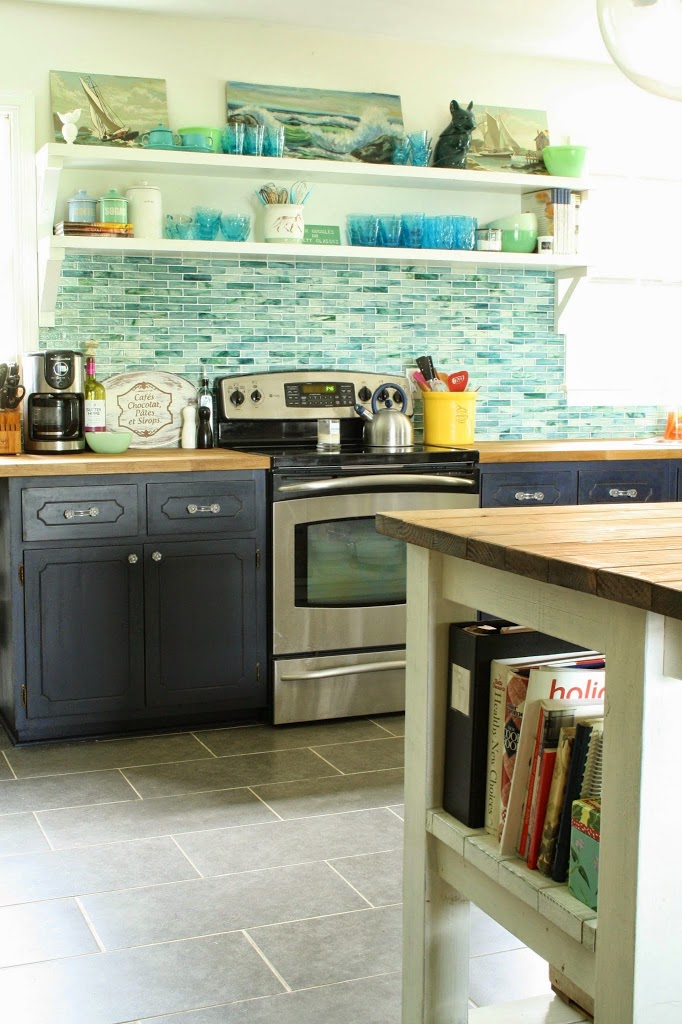 Beautiful kitchen with blue glass tile backsplash and open shelving kellyelko.com