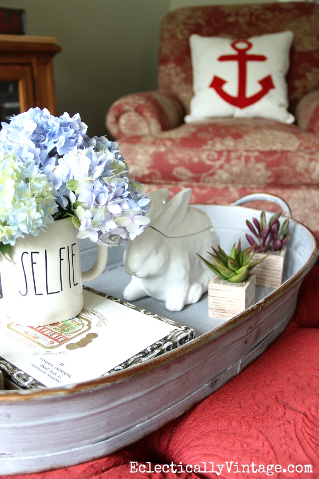 Love the huge tray on this red ottoman - perfect for display kellyelko.com