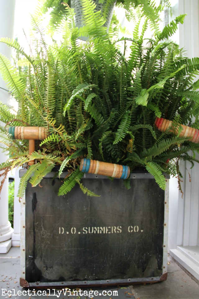 Huge old metal tub filled with ferns on this summer front porch - love the old croquet mallets peeking out kellyelko.com